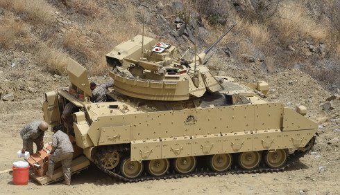 Saudi soldiers prepare their APC (Armoured Personnel Carrier) at a post on the Saudi-Yemeni border, in southwestern Saudi Arabia, on April 9, 2015. The Saudi-led coalition launched its air war on March 26, 2015, as the rebels closed on Yemeni President Abedrabbo Mansour Hadi's last refuge in Aden, prompting him to flee to neighbouring Saudi Arabia. AFP PHOTO / FAYEZ NURELDINE