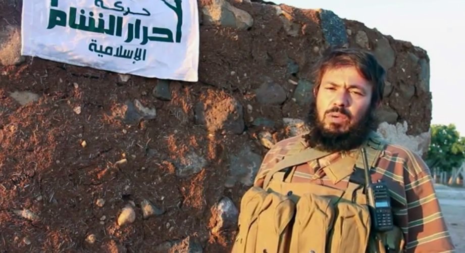 Militant with flag of  the Ahrar al-Sham Islamic Movement