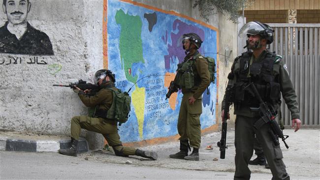 Israeli forces hold a position during clashes with Palestinian protesters at the Aida refugee camp, near the West Bank city of Bethlehem. 