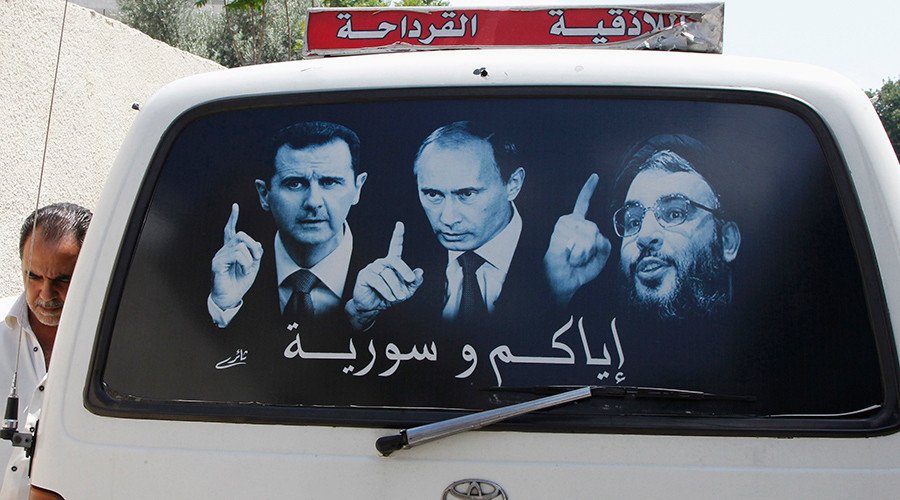 A poster showing Syrian President Bashar al-Assad (L), Russian President Vladimir Putin (C) and Lebanese Hezbollah leader Sayyed Hassan Nasrallah is seen on a micro bus in al-Qardahah town, near Latakia city © Khaled al-Hariri / Reuters