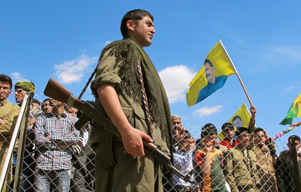 A PKK soldier stands in front of a crowd gathered in the Qandil mountains. Credit: Karlos Zurutuza/IPS