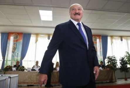 Belarusian President Alexander Lukashenko smiles at a polling station after voting during the presidential election in Minsk, Belarus, Sunday, Oct. 11, 2015. A presidential election was under way Sunday in Belarus, where authoritarian leader Alexander Lukashenko faced no serious competition and was expected easily to win a fifth term. The opposition called for a boycott of the vote. (AP Photo/Sergei Grits)