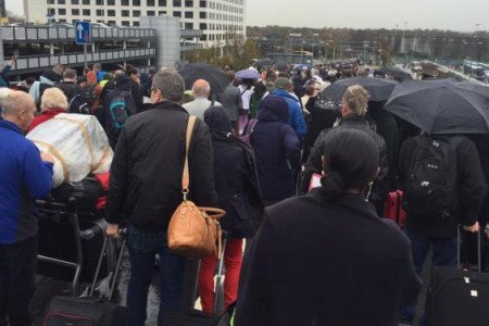 Evacuation: passengers stand in the rain outside the terminal (Tim Unwin)