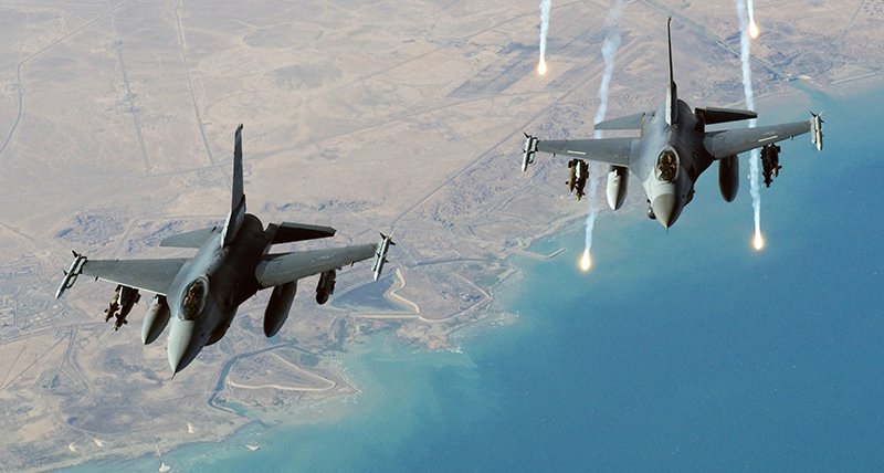 A single US Air Force F-16C Fighting Falcon aircraft from the 332nd Air Expeditionary Wing, Balad AB, Iraq, flying in a two man formation, launches electronic countermeasure flares, following an aerial refueling mission over Iraq, during Operation Iraqi Freedom.  (Air Force photo by Tech. Sgt. Scott Reed)