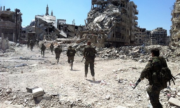 Syrian government forces patrol in Homs. Bombing on Saturday on a hospital in Zafarana killed seven people including a young girl, MSF have said in a statement.