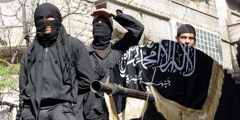 Members of jihadist group Al-Nusra Front take part in a parade calling for the establishment of an Islamic state in Syria, at the Bustan al-Qasr neighbourhood of Aleppo, on October 25, 2013. The conflict in Syria, which erupted after President Bashar al-Assad launched a bloody crackdown on Arab Spring-inspired democracy protests, is believed to have killed more than 115,000 people. AFP PHOTO / KARAM AL-MASRI        (Photo credit should read KARAM AL-MASRI/AFP/Getty Images)