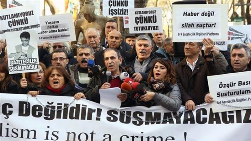 Turkish journalists hold a banner reading "Journalism is not a crime" during a demonstration in the capital Ankara, January 10, 2016.