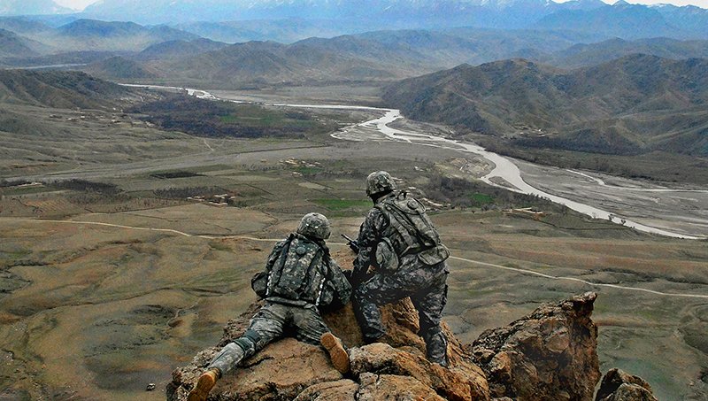 U.S. Army 1LT Jared Tomberlin (left) from Bravo Company, 1st Battalion, 4th Infantry Regiment gets a first hand view of the land with outgoing commander 1LT Larry Baca  from Charlie Co. 1-4, on top of a ridge near Forward Operation Base Lane, Zabul Province, Afghanistan, on February 21, 2009. (U.S. Army photo by Staff Sergeant Adam Mancini / Released)