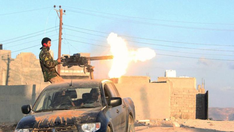 A fighter of Libya's Fajr Libya group (Libyan Dawn) fires his gun during clashes in the hill village of Kikla, southwest of Tripoli on October 21, 2014. The internationally recognised Libyan government called for a civil disobedience campaign in Tripoli until its forces retake the capital from militias who seized it. (Photo: AFP-Mohammed Turkia)
