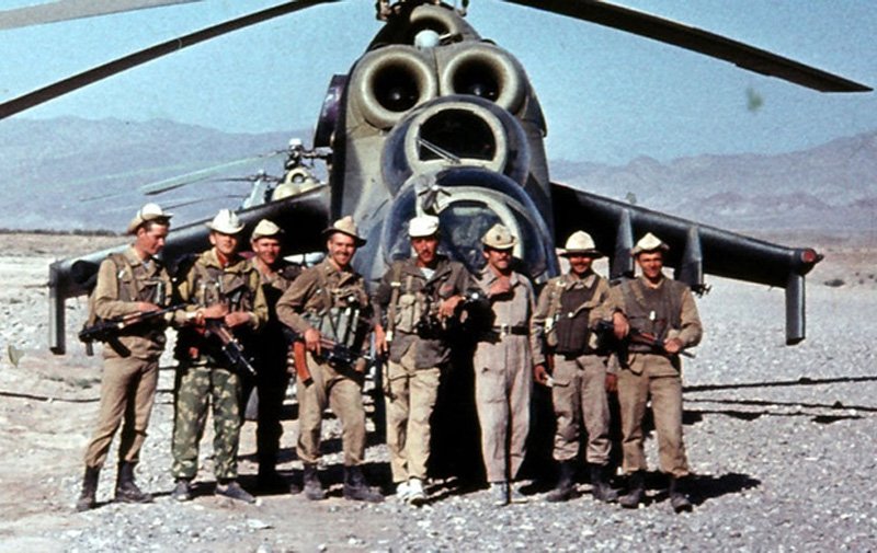 Soviet pilots and aircrew posing with Mil Mi-24Ds in Afghanistan.