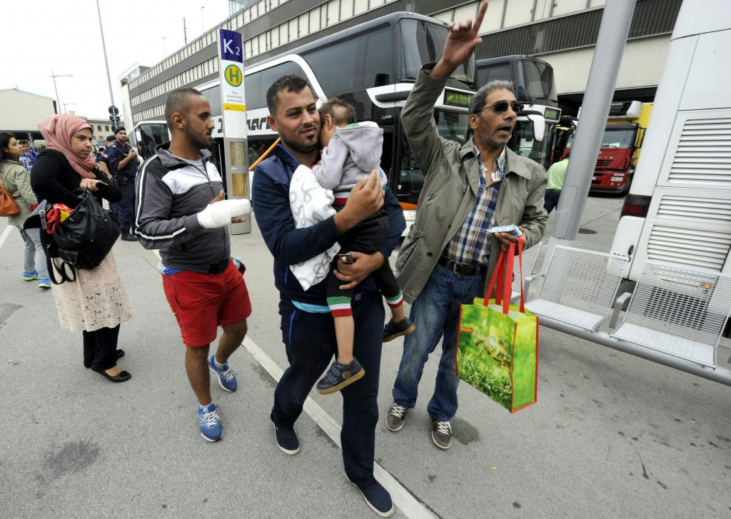 Refugees after getting off a bus arriving from the Hungarian border to Vienna, Austria, 05 September 2015. Austrian police say they expect 10,000 arrivals out of Hungary now that Hungary has allowed migrants held up there to travel further west after they had suffered days of ordeal in Hungary. Many of them, mostly Syrian refugees, are presumed to immediately continue their journey onwards to Germany after receving initial care in Austria.  EPA/HERBERT PFARRHOFER