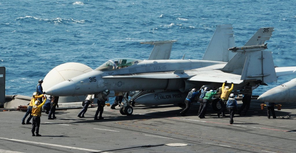 Sailors guide an F/A-18C Hornet assigned to the Valions of Strike Fighter Squadron (VFA) 15 on the flight deck of the aircraft carrier USS George H.W. Bush (CVN 77) in the Gulf, in this handout image taken and released on August 8, 2014. Two F/A-18 aircraft from the squadron conducted an airstrike on Friday against Islamic State artillery used against Kurdish forces defending the city of Arbil, near U.S. personnel, a Pentagon spokesman said. REUTERS/Mass Communication Specialist 3rd Class Lorelei Vander Griend/U.S. Navy/Handout via Reuters (Tags: - Tags: MILITARY CONFLICT TPX IMAGES OF THE DAY) ATTENTION EDITORS - THIS PICTURE WAS PROVIDED BY A THIRD PARTY. REUTERS IS UNABLE TO INDEPENDENTLY VERIFY THE AUTHENTICITY, CONTENT, LOCATION OR DATE OF THIS IMAGE. FOR EDITORIAL USE ONLY. NOT FOR SALE FOR MARKETING OR ADVERTISING CAMPAIGNS. THIS PICTURE IS DISTRIBUTED EXACTLY AS RECEIVED BY REUTERS, AS A SERVICE TO CLIENTS