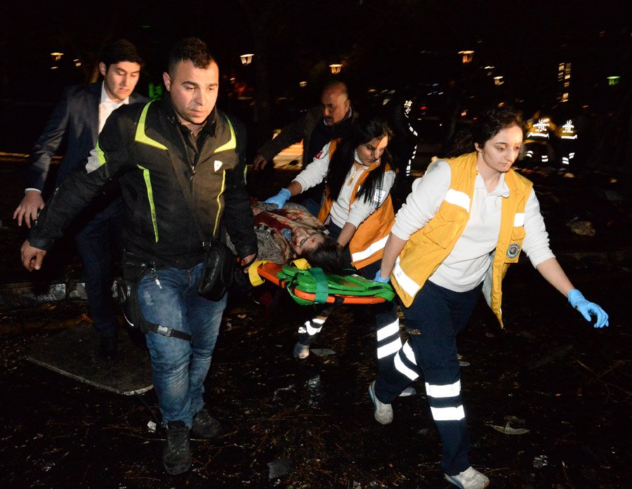 ANKARA, TURKEY - MARCH 13:  (EDITORS NOTE: Image contains graphic content.) Emergency services help an injured person following after an explosion in Ankara's central Kizilay district on March 13, 2016 in Ankara, Turkey. The Ankara governor's office has reported that at least 27 people have been killed and 75 wounded in an explosion in the Turkish capital Ankara. The explosion is believed to have been a car bomb attack according to Ankara governor Mehmet Kiliclar. (Photo by Defne Karadeniz/Getty Images)
