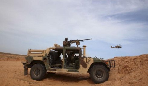 A Tunisian soldier holds his position during an exercise along the frontier with Libya in Sabkeht Alyun