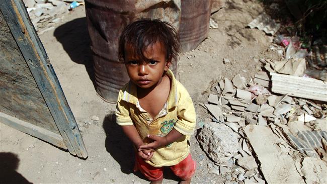 A Yemeni child stands outside the family house which was destroyed in a Saudi strike at a slum in the capital Sana’a, on March 12, 2016. ©AFP