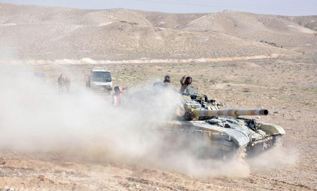 Forces loyal to Syria's President Bashar al-Assad drive a tank during their offensive to recapture the historic city of Palmyra in this picture provided by SANA on March 24, 2016.