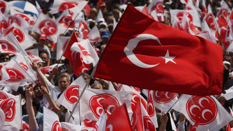Supporters, known as " Gray Wolves" listen to Devlet Bahceli, the leader of Turkish opposition Nationalist Action Party, MHP, in Ankara, Turkey, Saturday, June 4, 2011. About 52 million Turks will vote in the June 12 general elections that have been marred by the release on the Internet of sex videos that have led to the resignation of 10 prominent opposition politicians. (AP Photo/Burhan Ozbilici)