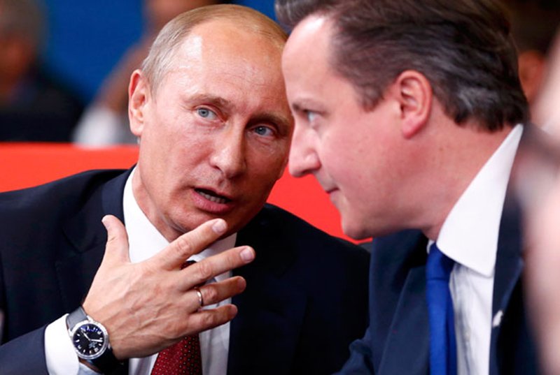 Russian President Vladimir Putin and Britain's Prime Minister David Cameron (R) chat as they watch the women's -78kg and men's 100kg judo competition at the London 2012 Olympic Games August 2, 2012. REUTERS/Darren Staples (BRITAIN - Tags: OLYMPICS SPORT JUDO POLITICS)