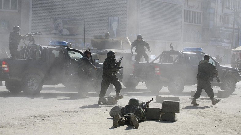 Afghan security forces run for the site of Afghan Justice Ministry following an attack in Kabul, Afghanistan on Wednesday, Feb. 11, 2009. Assailants, some wearing suicide vests, attacked the Justice Ministry and another government building in Afghanistan's capital Wednesday, causing multiple deaths and forcing workers to flee from building windows. The Taliban claimed responsibility for the attacks. (AP Photo/Musadeq Sadeq)