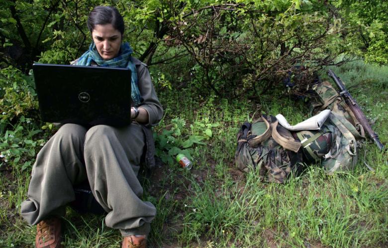 A female Kurdistan Workers' Party (PKK) fighter works on her laptop after arriving in the northern Iraqi city of Dohuk on 14 May 2013, after leaving Turkey as part of a peace drive with Ankara. (Photo: AFP -Safin Hamed)