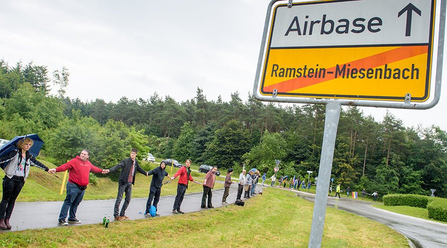 Activists attend a rally "Stop-Ramstein" on the road leading to US Air Force Base in Ramstein-Miesenbach on June 11, 2016. © Oliver Dietze / DPA / AFP