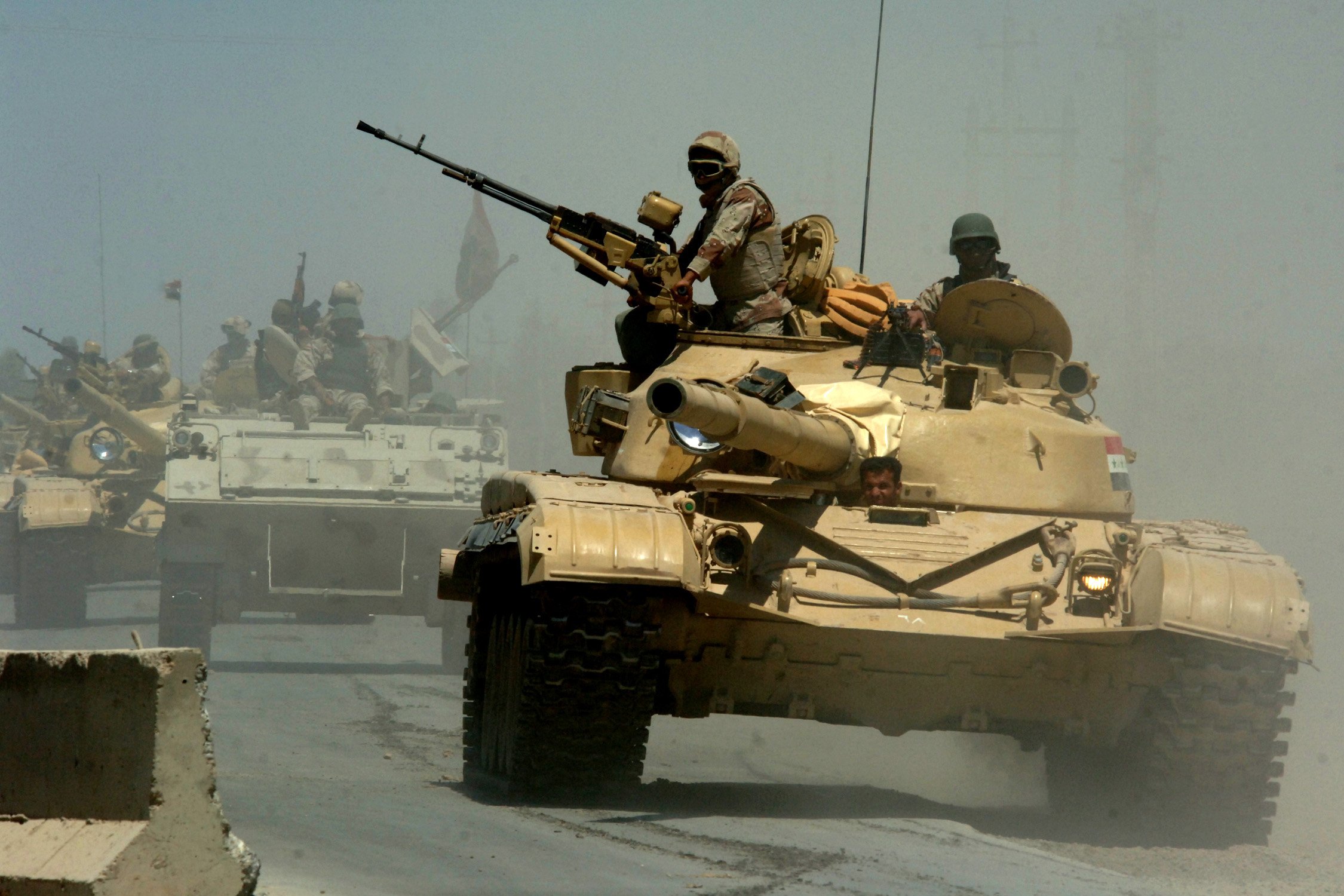 (May 18, 2006) Mushahda, Iraq.Iraqi tanks from the Iraqi Army 9th Mechanized Division pass through a highway checkpoint on their way to Forward Operating Base Camp Taji, Iraq..U.S. Navy photo by Photographer's Mate 1st Class Michael Larson. (RELEASED)