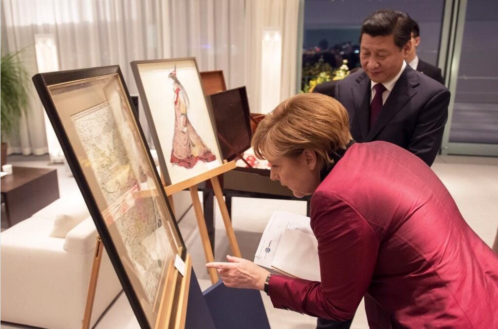 Angela Merkel and Xi Jinping study a medieval map of China
