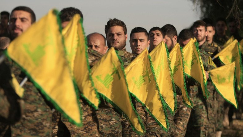 Hezbollah fighters hold flags as they attend the memorial of their slain leader Sheik Abbas al-Mousawi, who was killed by an Israeli airstrike in 1992, in Tefahta village, south Lebanon, Saturday, Feb. 13, 2016.  (AP Photo/Mohammed Zaatari)