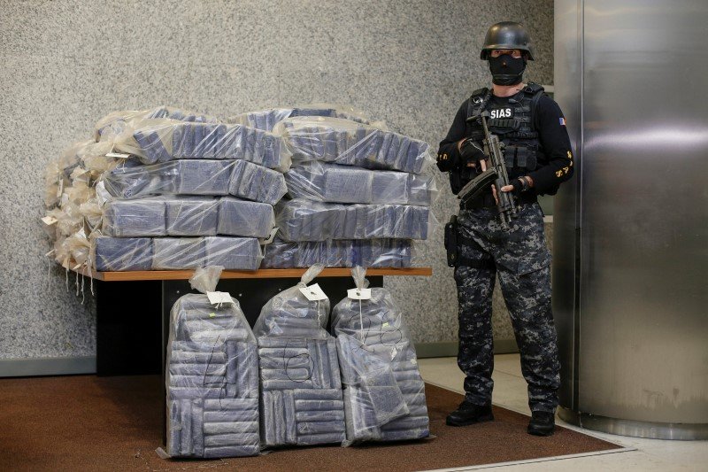 A Romanian special forces unit member stands guard near bags containing part of 2.5 tonnes of cocaine seized in the Black Sea port of Constanta. Inquam Photos/Octav Ganea/via REUTERS