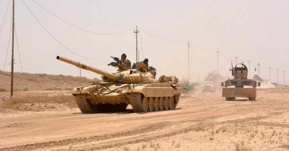 Iraqi government forces drive a tank on June 22, 25 miles west of Qayyarah, where they seized control of an airfield July 9. (Mahmud Saleh/AFP via Getty Images)