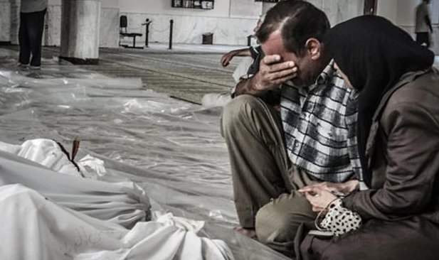 A Syrian couple mourn following the 2013 attack on Eastern Ghouta (REX/Erbin News/NurPhoto)