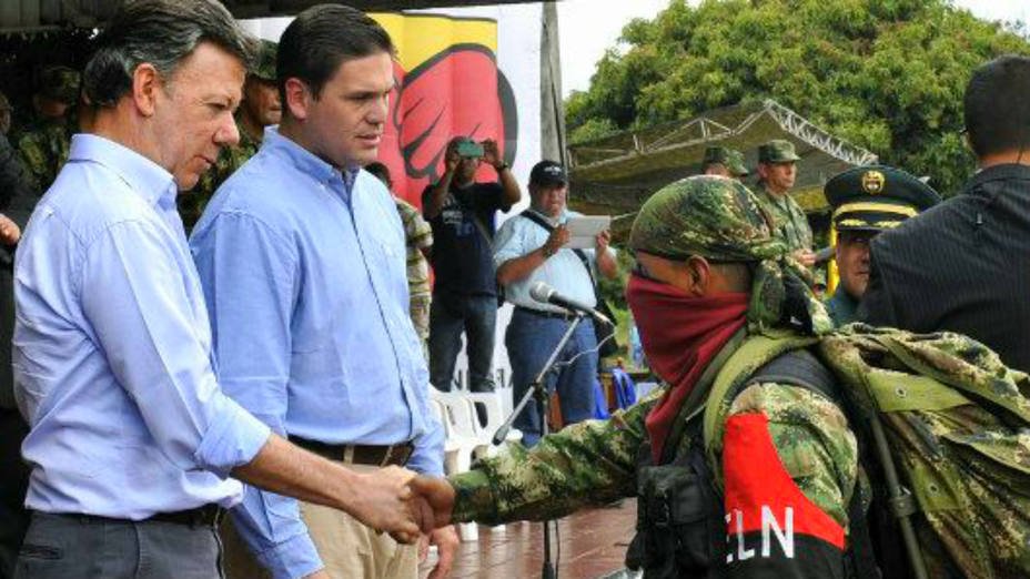 Colombian President Juan Manuel Santos and an ELN militant
