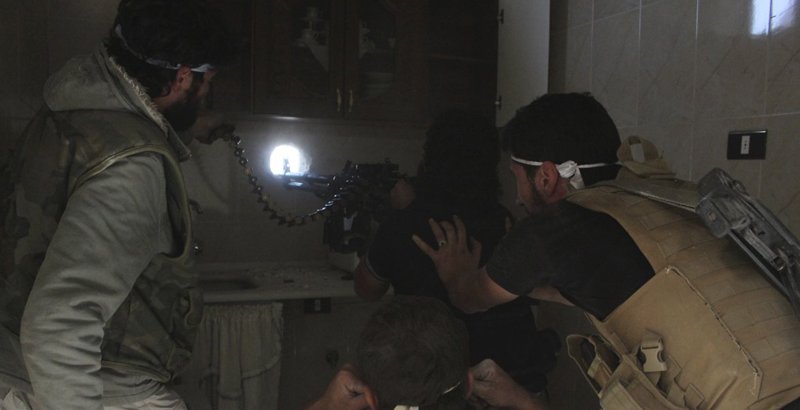 Fig.2 Machine gunner points his weapon through a firing port drilled in a concrete wall.