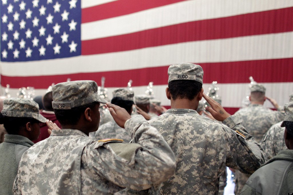Soldiers salute the U.S. flag during a recitation of the Pledge of Allegiance at a welcome home ceremony for soldiers returning from a deployment in Afghanistan, at Fort. Carson, Colo., Wednesday Dec. 5, 2012. Nearly 300 soldiers of the 4th Brigade Combat Team, 4th Infantry Division, returned home after a tour of duty that began in February. (AP Photo/Brennan Linsley)