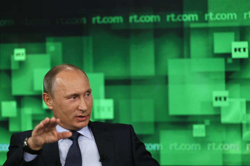 Russian President Vladimir Putin spoke during his visit to the new studio of television channel RT in Moscow. The Russian government said it would cut the funding of the TV network by almost 9 percent next year. Photo: Yuri Kochetkov/Reuters/Pool