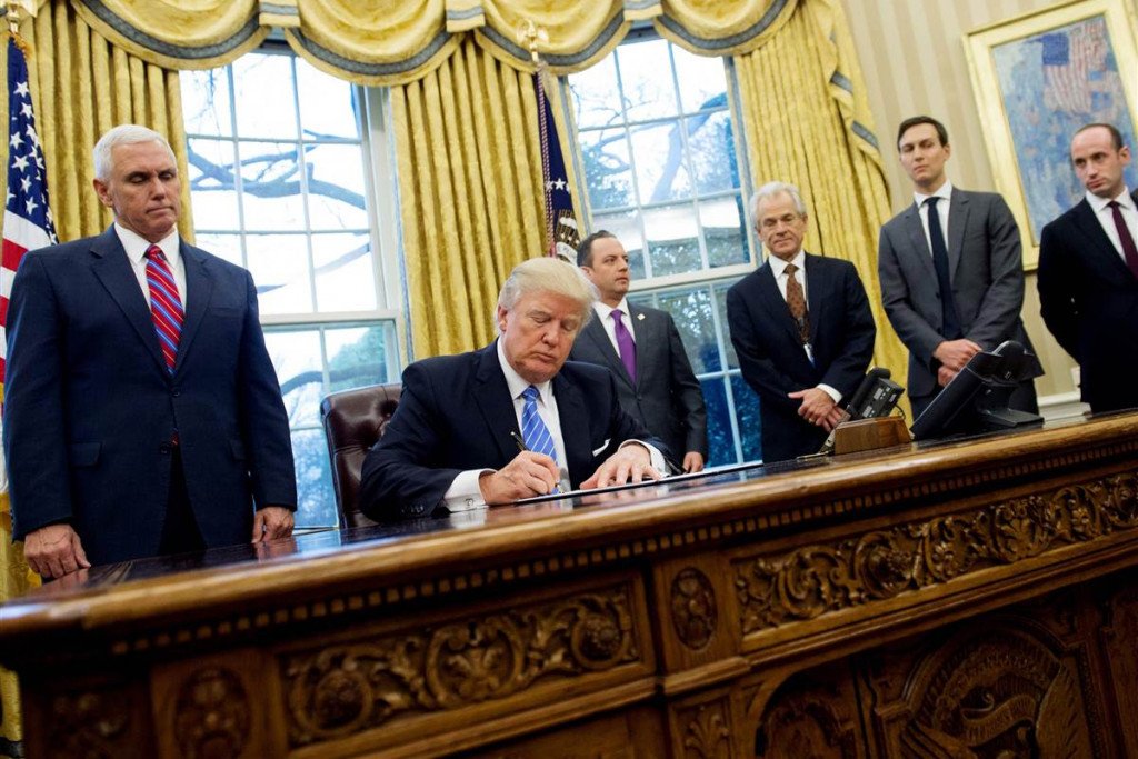 President Donald Trump signs an executive order in the Oval Office of the White House in Washington, D.C., January 23, 2017. Saul Loeb / AFP - Getty Images