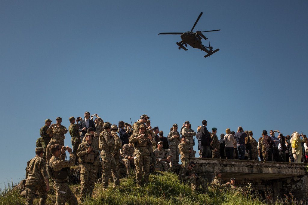 Observers during a military exercise involving multiple nations at Camp Adazi in Latvia in 2015. Credit Bryan Denton for The New York Times