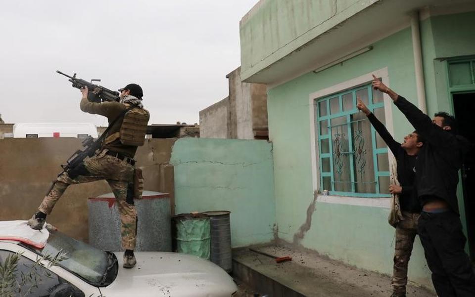 An Iraqi special forces soldier fires at a drone operated by Islamic State militants Islamic State militants in Mosul on March 4. (Reuters Photo)